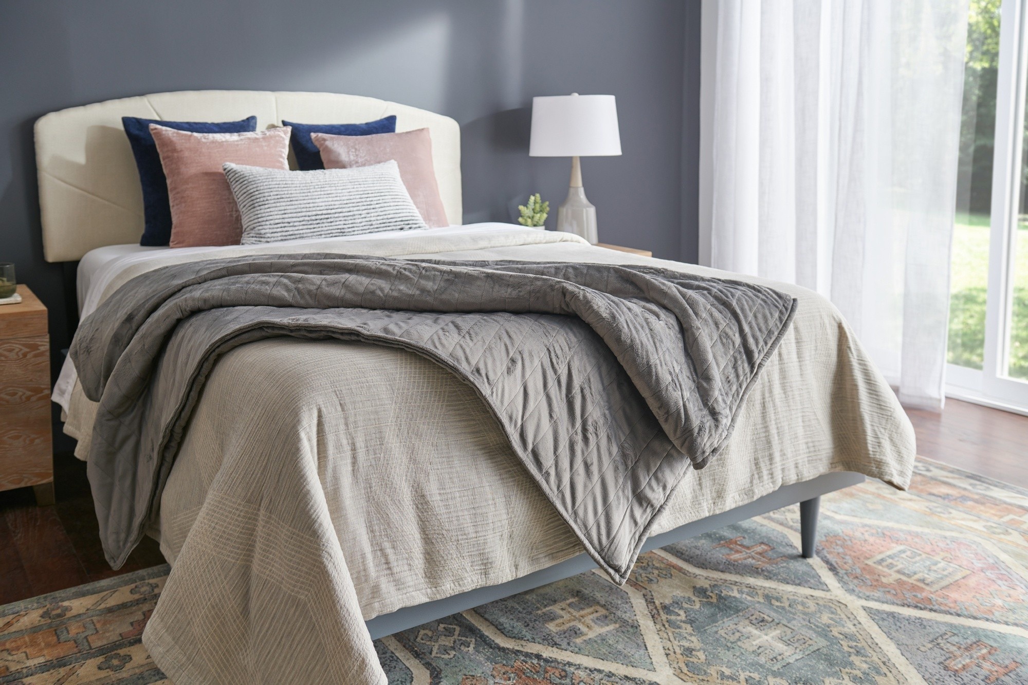 Tempur-Pedic Weighted Blanket draped on a dressed bed